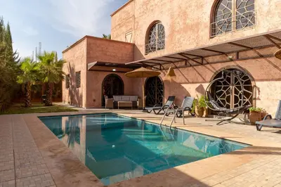 a swimming pool in front of a building at Villa a Marrakech with private pool in Marrakech
