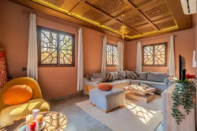 a living room with a couch and a table at Villa a Marrakech with private pool in Marrakech
