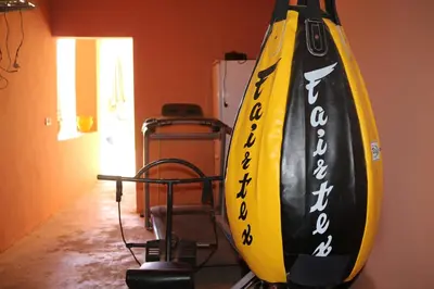 a surfboard hanging on a wall in a room at Niche paradis in Aghmat