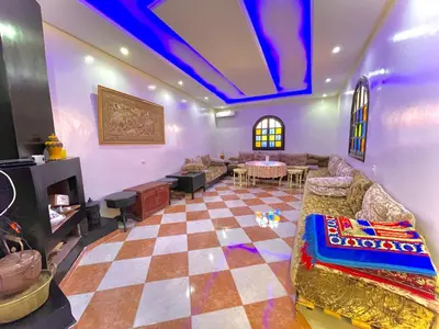 a living room with a couch and a table at Niche paradis in Aghmat