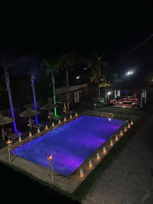 a large swimming pool at night with lights at Riad Marjana in Marrakech