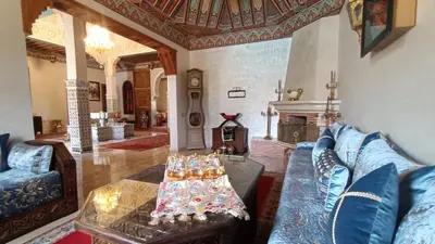 a living room with a couch and a table at Riad Marjana in Marrakech