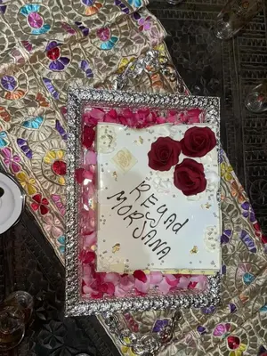a birthday cake with roses on top of a table at Riad Marjana in Marrakech