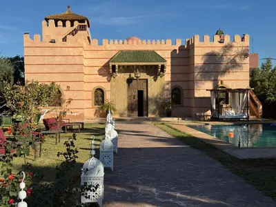 a building with a pool in front of it at Riad Marjana in Marrakech