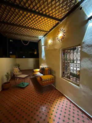 a living room with a couch and a table at Appartement Authentique à la Médina de Fès - À Deux Pas de Bab Bou Jeloud & des Souks in Fès al Bali