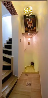 a hallway with stairs and a painting on the wall at Appart Sahraoui Medina in Fès al Bali
