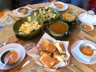 a table topped with plates of food and bowls of food at Dar Sidi Bounou in Mhamid