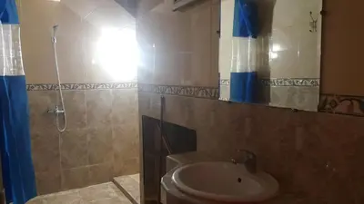 a bathroom with a toilet and a shower and a sink at Bassatine appartement in Meknès