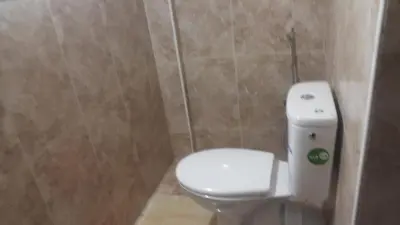 a bathroom with a white toilet in a room at Bassatine appartement in Meknès