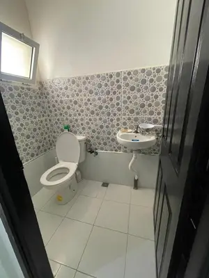 a bathroom with a toilet and a sink at WiFi & Smart TV & Netflix & Free Parking & Full Kitchen & Heating & Washing Machine in Khemisset