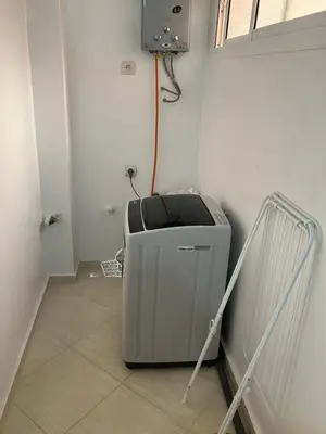 a room with a heater in the corner of a room at WiFi & Smart TV & Netflix & Free Parking & Full Kitchen & Heating & Washing Machine in Khemisset