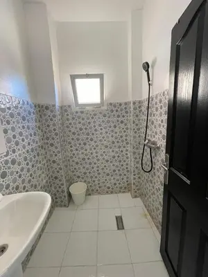 a bathroom with a tub and a toilet and a sink at WiFi & Smart TV & Netflix & Free Parking & Full Kitchen & Heating & Washing Machine in Khemisset