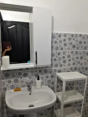 a bathroom with a sink and a mirror at WiFi & Smart TV & Netflix & Free Parking & Full Kitchen & Heating & Washing Machine in Khemisset