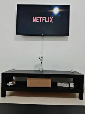 a flat screen tv sitting on top of a table at WiFi & Smart TV & Netflix & Free Parking & Full Kitchen & Heating & Washing Machine in Khemisset