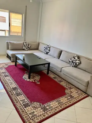 a living room with a couch and a coffee table at WiFi & Smart TV & Netflix & Free Parking & Full Kitchen & Heating & Washing Machine in Khemisset