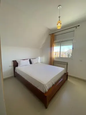a bedroom with a bed and a window at Cedar Peak Residence in Ifrane