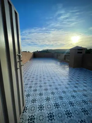 a balcony with a tile floor on a roof at MARRAKECH , Ourika in Ourika