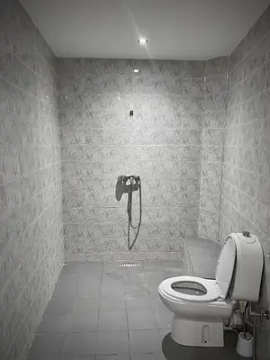 a bathroom with a toilet and a shower in it at MARRAKECH , Ourika in Ourika