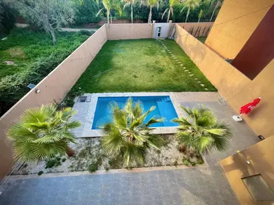 an overhead view of a swimming pool with palm trees at MARRAKECH , Ourika in Ourika