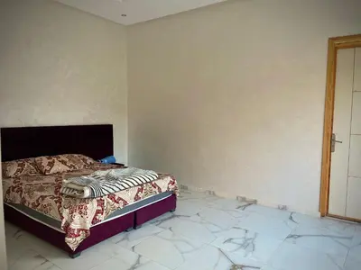 a bedroom with a bed in the corner of a room at MARRAKECH , Ourika in Ourika