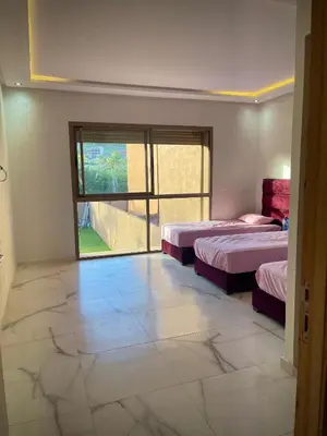 a room with two beds and a large window at MARRAKECH , Ourika in Ourika