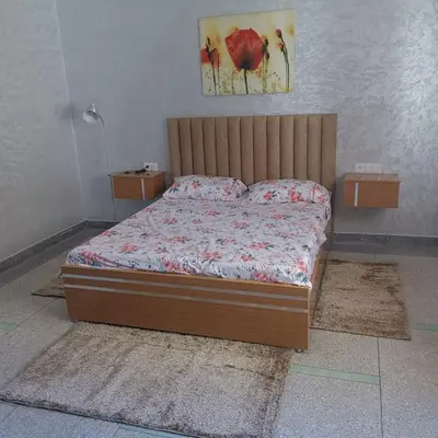 a bed sitting in a bedroom with avertisement at Superbe maison près de la gare de train in Fès