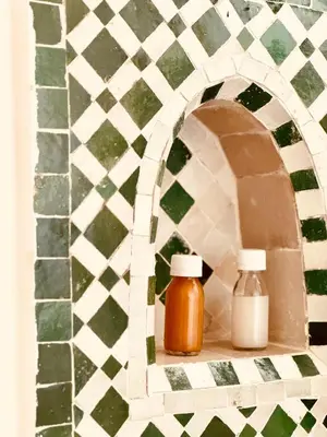 two bottles of honey sitting on a shelf in a wall at Riad Zawiyat Fes in Fès