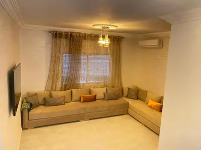 a living room with a couch in front of a window at طريق صفرو قرب المستشفى الجامعي و قرب مستشفي أكديطال in Fès