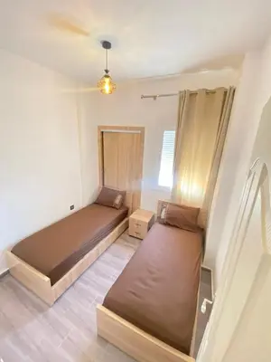 a bedroom with two beds in a room at طريق صفرو قرب المستشفى الجامعي و قرب مستشفي أكديطال in Fès