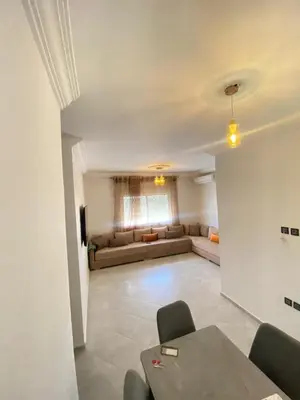 a living room with a couch and a table at طريق صفرو قرب المستشفى الجامعي و قرب مستشفي أكديطال in Fès