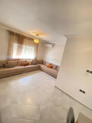 a large living room with a couch and a table at طريق صفرو قرب المستشفى الجامعي و قرب مستشفي أكديطال in Fès