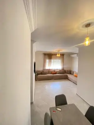 a living room with a couch and a table at طريق صفرو قرب المستشفى الجامعي و قرب مستشفي أكديطال in Fès