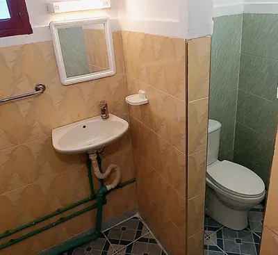 a bathroom with a sink and a toilet at Riad Taourirte in Tinerhir