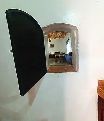 an open door to a room with a dining room at Riad Taourirte in Tinerhir