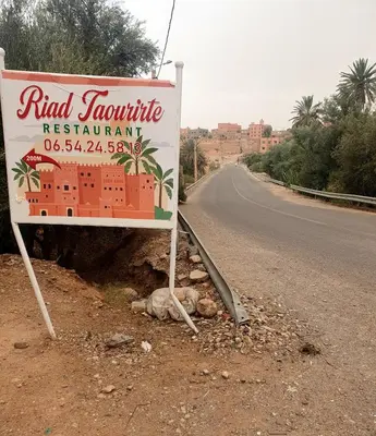 a sign on the side of a road at Riad Taourirte in Tinerhir