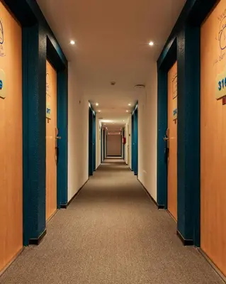 a corridor of an office with orange and blue walls at MIA Urban Fès in Fès
