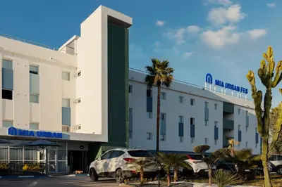 a hotel with cars parked in front of it at MIA Urban Fès in Fès