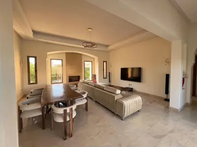a living room with a couch and a table at Luxueuse villa contemporaine KIMANU à 20 min de Marrakech in Marrakech
