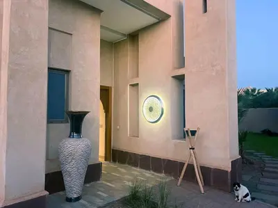 a large vase sitting on the side of a building at Luxueuse villa contemporaine KIMANU à 20 min de Marrakech in Marrakech