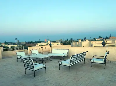 a group of chairs and tables on a patio at Luxueuse villa contemporaine KIMANU à 20 min de Marrakech in Marrakech