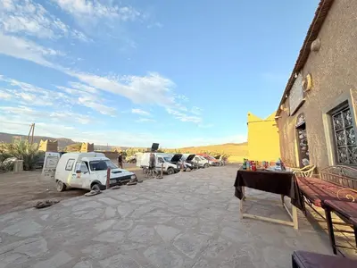a group of cars parked next to a building at Auberge Dar Lajdoud in Tafraoute Sidi Ali