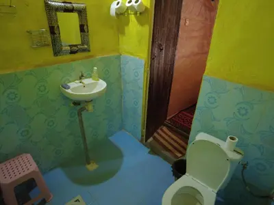 a small bathroom with a toilet and a sink at Auberge Dar Lajdoud in Tafraoute Sidi Ali