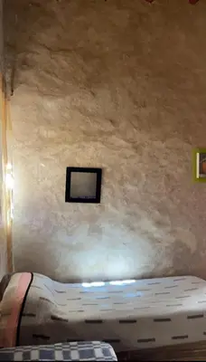 a bed in a room with a wall at Maison Chez Lahcen - Akka Nait Sidi - Tissint in Tissint