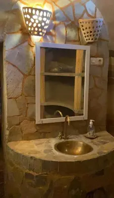 a bathroom with a sink and a mirror at Maison Chez Lahcen - Akka Nait Sidi - Tissint in Tissint