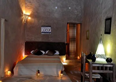 a bedroom with a bed with lights on it at Maison Chez Lahcen - Akka Nait Sidi - Tissint in Tissint