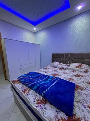 a bedroom with a bed with a blue ceiling at Chambre Auberge in Fès