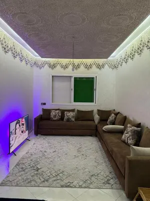 a living room with a couch and a tv at Chambre Auberge in Fès