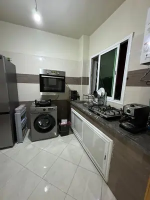 a kitchen with a washing machine and a sink at Chambre Auberge in Fès
