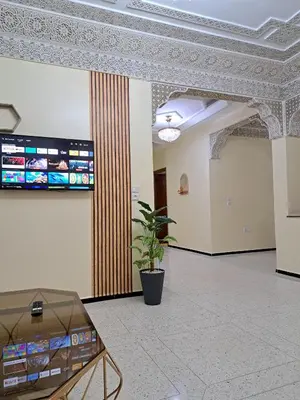 a lobby with a glass table in a building at Appartement Atlas City Center in Fès