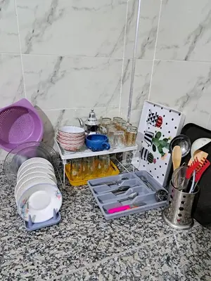 a kitchen counter with utensils and other kitchen items at Appartement Atlas City Center in Fès
